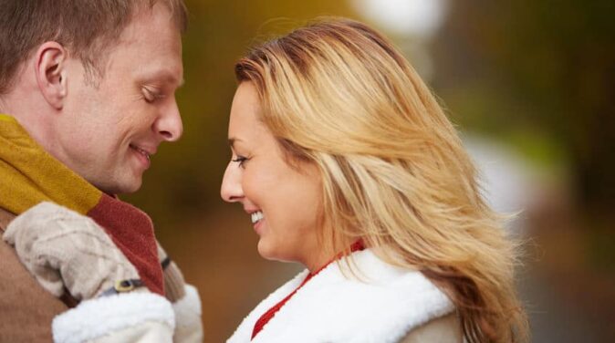 Lovely couple wearing sweater hugging each other