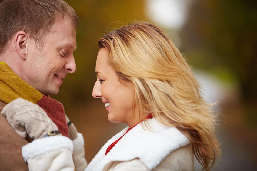 Lovely couple wearing sweater hugging each other