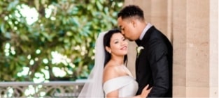 groom kissing his bride on the head