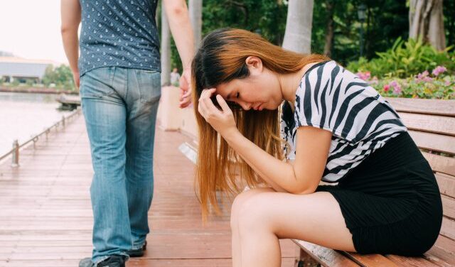 man walking away from woman with broken =heart