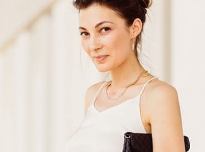 Woman in white top with her black purse