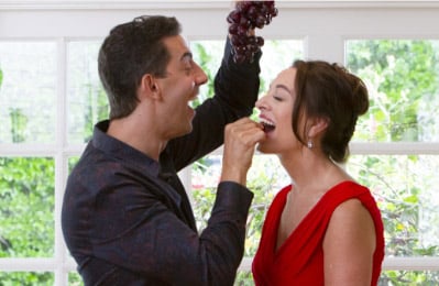 Evan Marc Katz feeding grapes to his wife