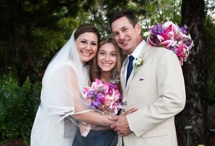 middle-aged couple getting married with their teen-aged daughter