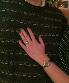 Love U success story of a strong smart successful woman showing off her engagement rings with red nails