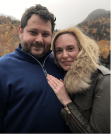 happily engaged smart strong successful woman leaning proudly showing off her engagement ring on boyfriend's chest