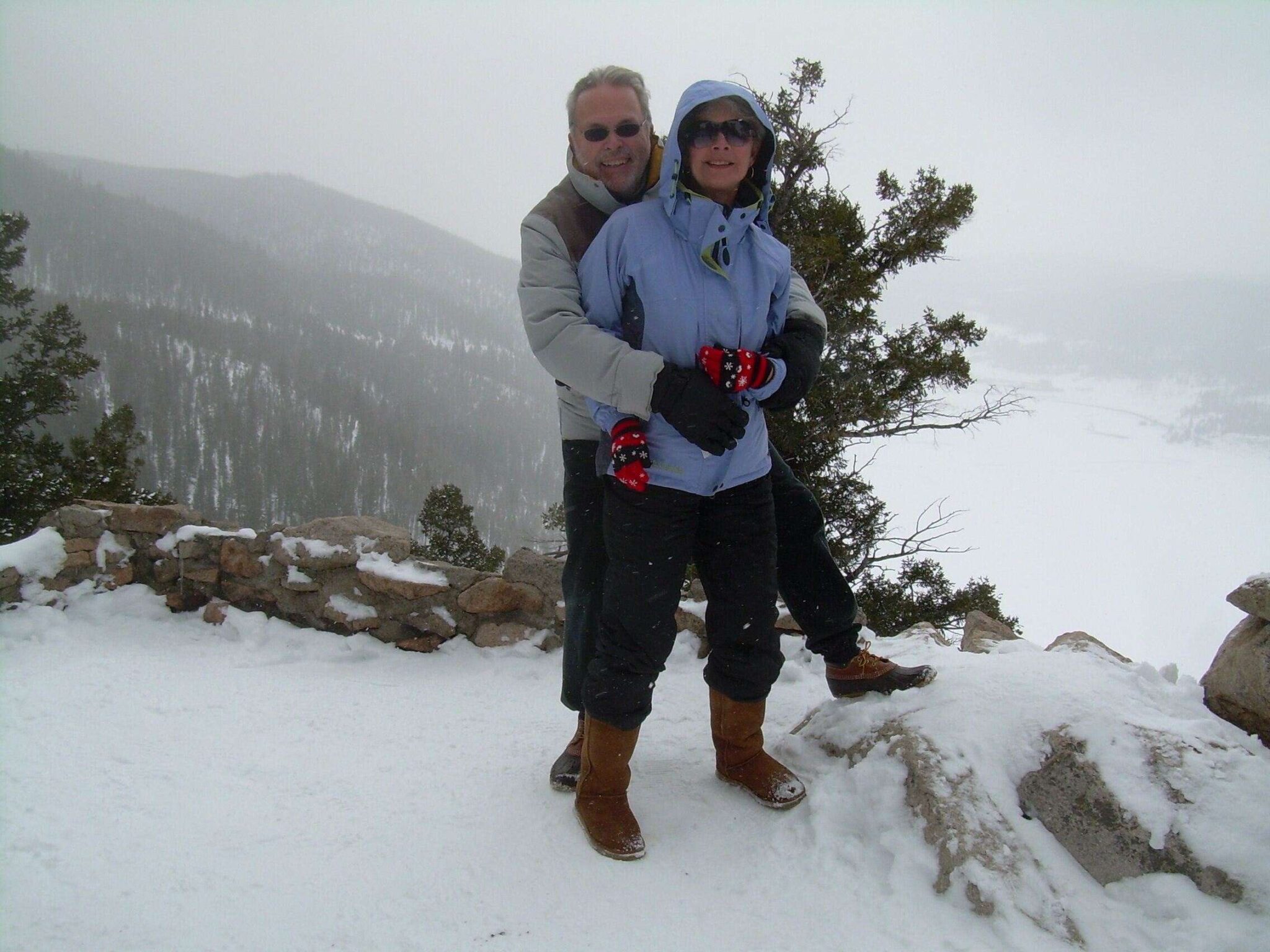 happy couple hugging in snow