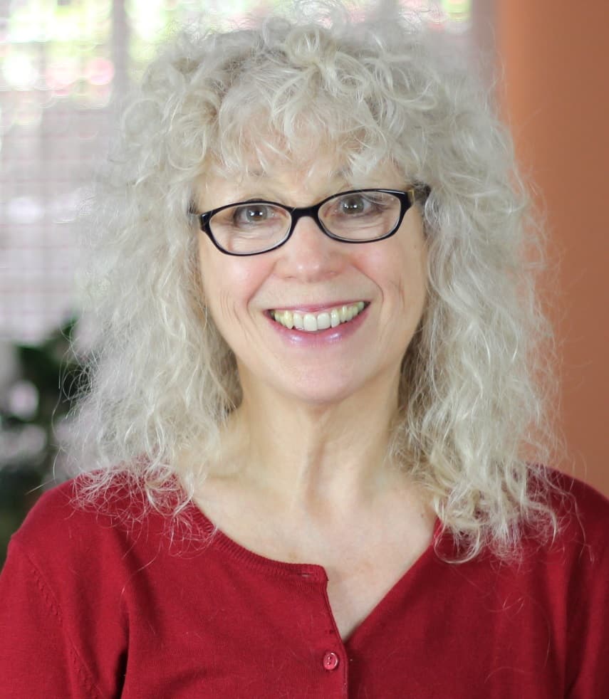 smart strong successful woman with white curly hair wearing glasses and smiling