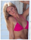 A blonde woman in a sexy pink bikini top.